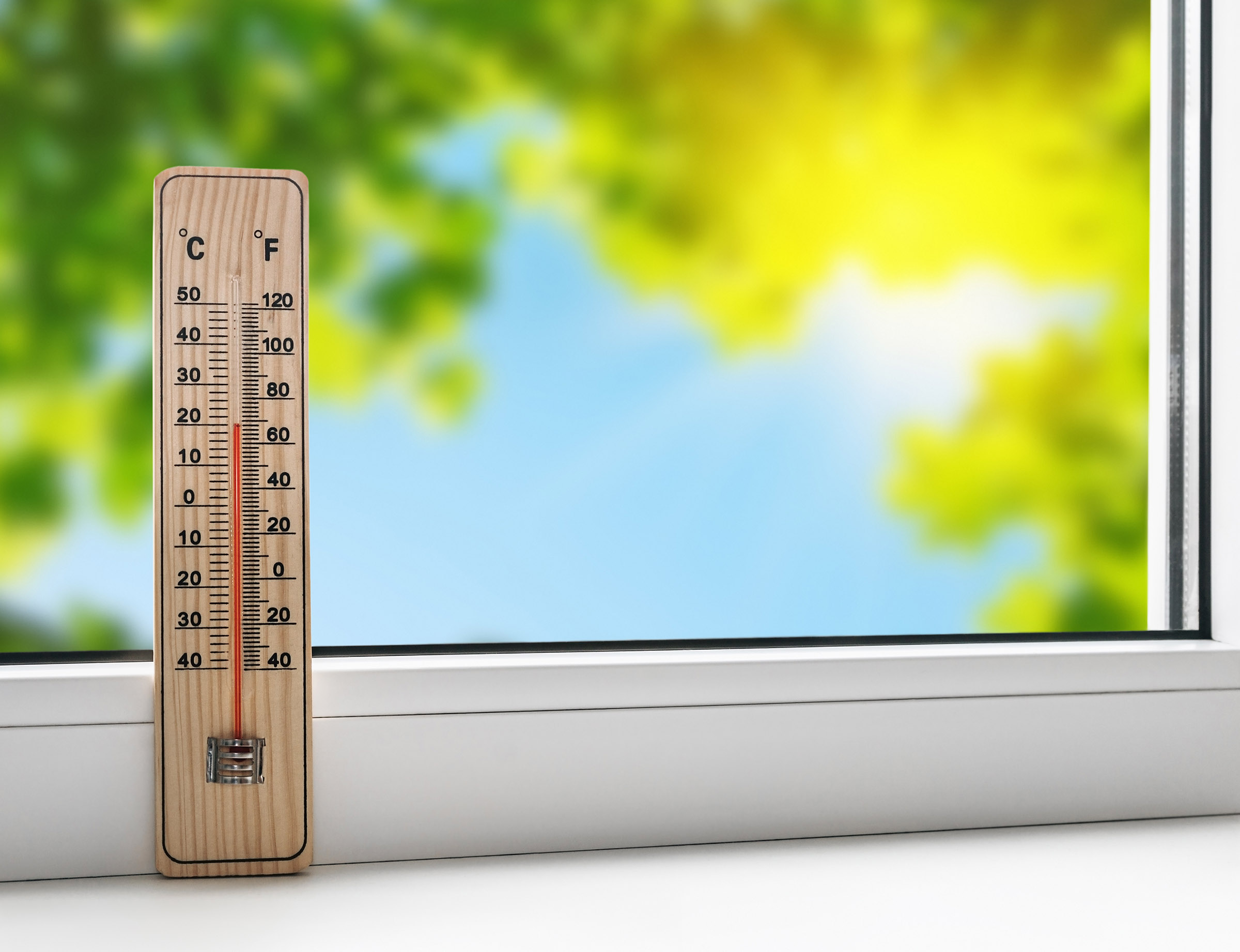thermometer on windowsill, showcasing rising global temps