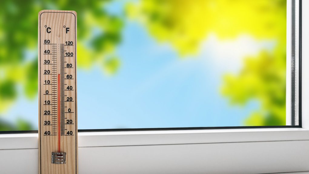 thermometer on windowsill, showcasing rising global temps