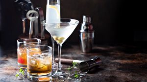 Alcohol Health Variety of alcoholic cocktails on dark background.