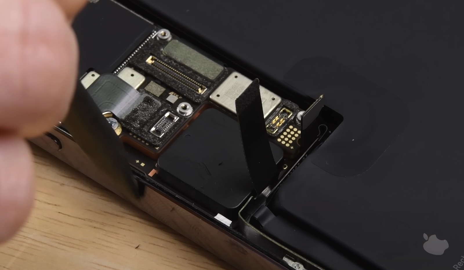 iPhone 14 Pro Max teardown shows a black plastic component instead of the SIM tray.