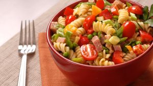 A bowl of ready-to-eat pasta salad on a table.