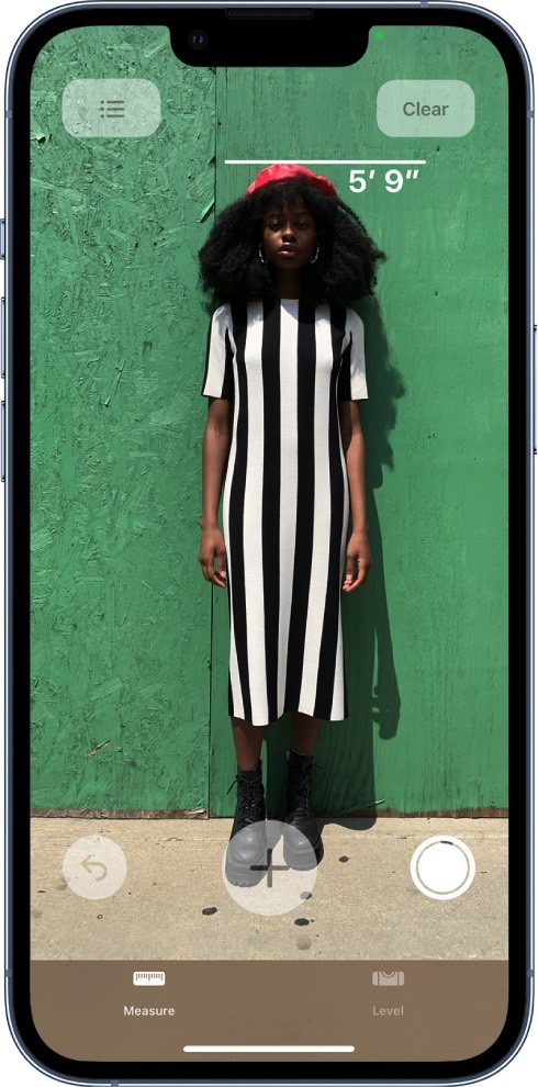 Measuring someone's height with the iPhone's Measure AR app.