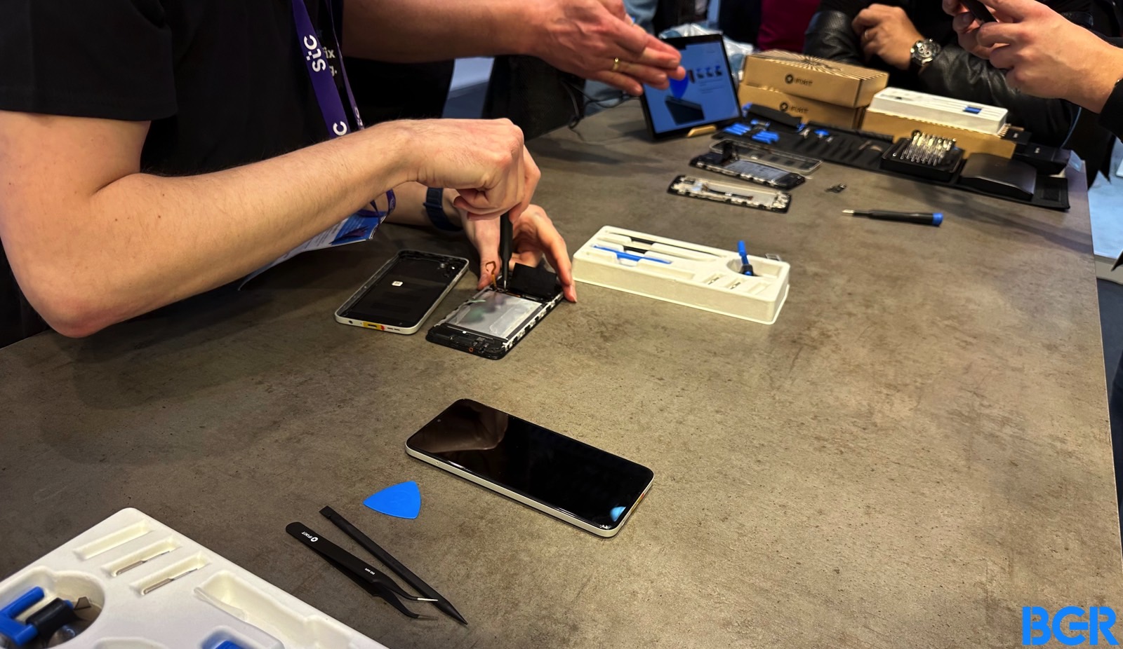 iFixit experts dismantling the Nokia G22 at MWC 2023.