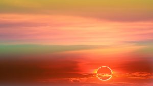 annular eclipse over soft cloud colorful sunset sky