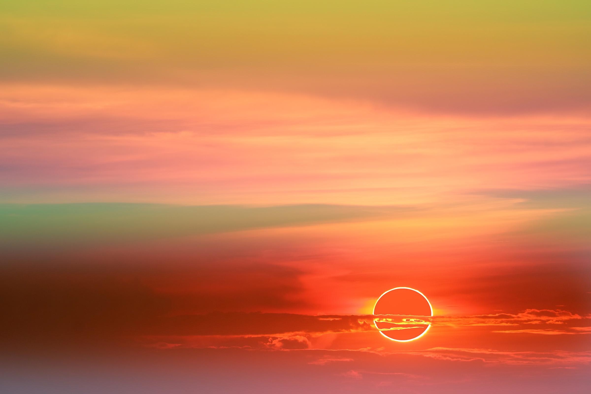 annular eclipse over soft cloud colorful sunset sky