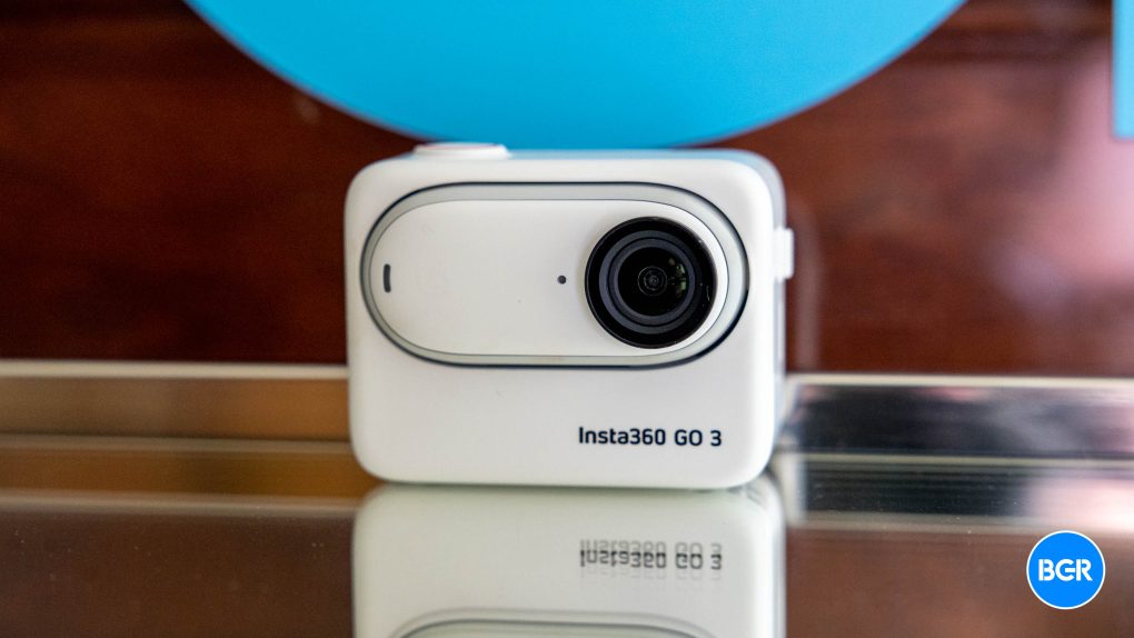 Insta360 GO 3 Action Camera on a mirror in front of a BGR logo