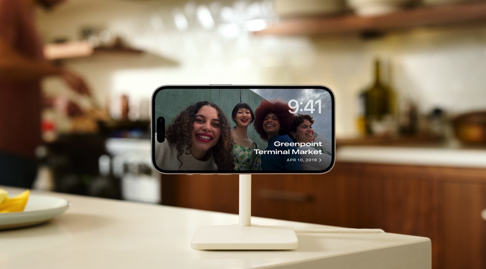 An iPhone in StandBy mode on a kitchen counter.