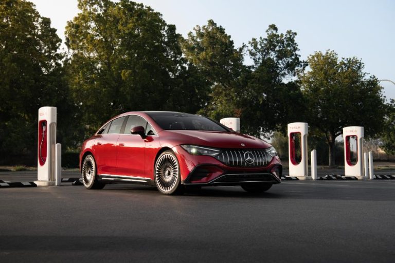 Mercedes in front of a Tesla Supercharger