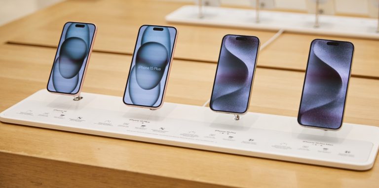 iPhone 15 models in an Apple retail store.