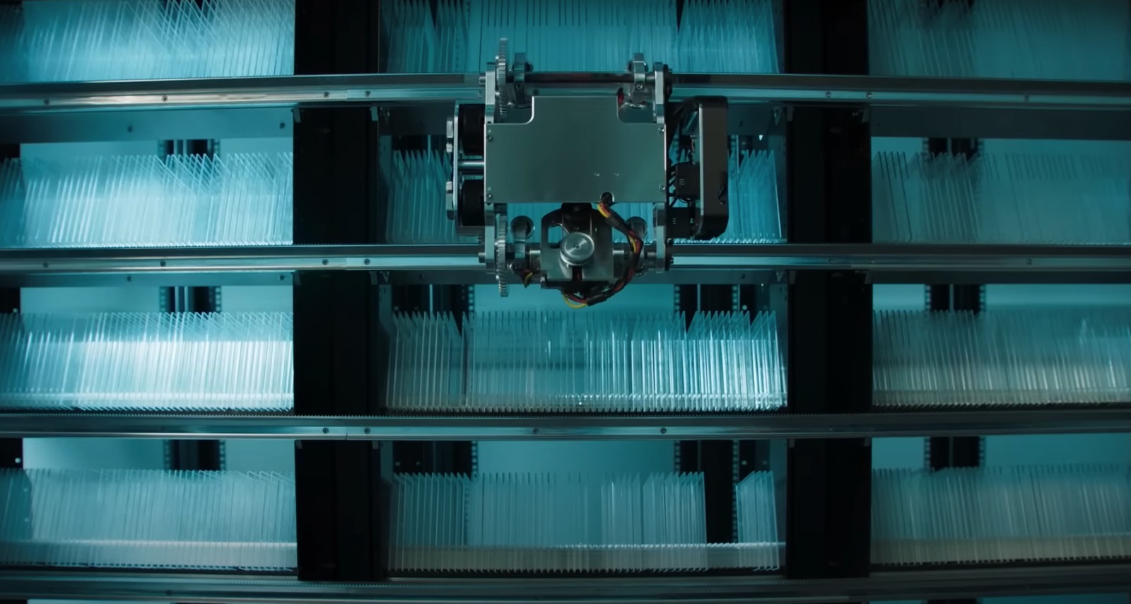 A robot navigating a library of glass sheets, looking to retrieve a specific piece.