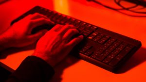 Data breach Hacker stealing information on a computer keyboard.