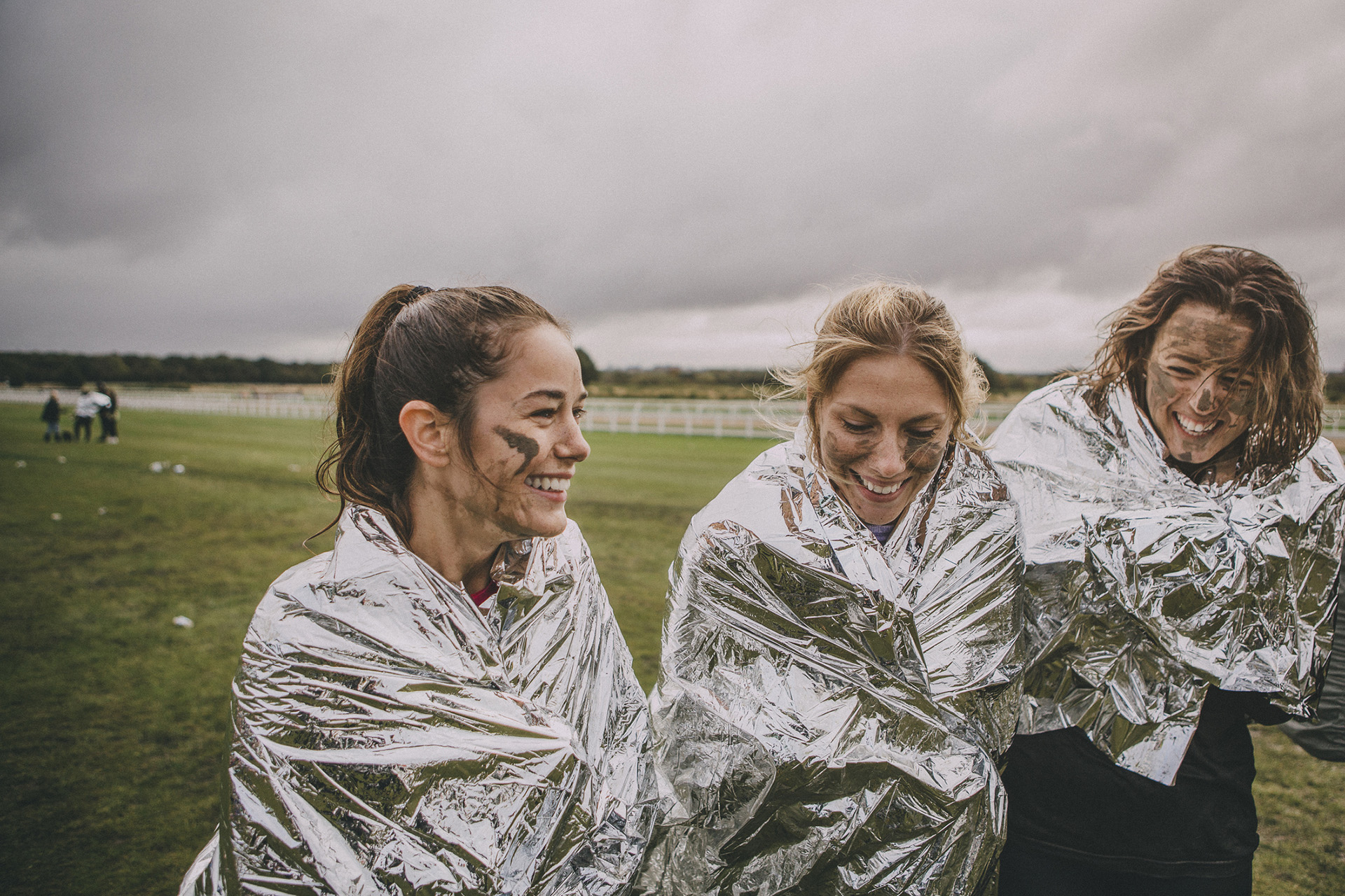 people wearing thermal blankets