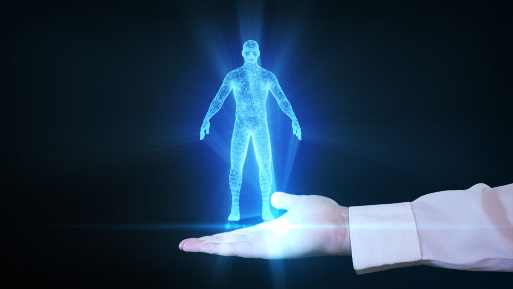 Businessman is holding a human hologram in his hand