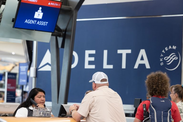 A Delta agent helps passengers after cancelled and delayed flights at Hartsfield-Jackson Atlanta International Airport on July 22, 2024 in Atlanta, Georgia.