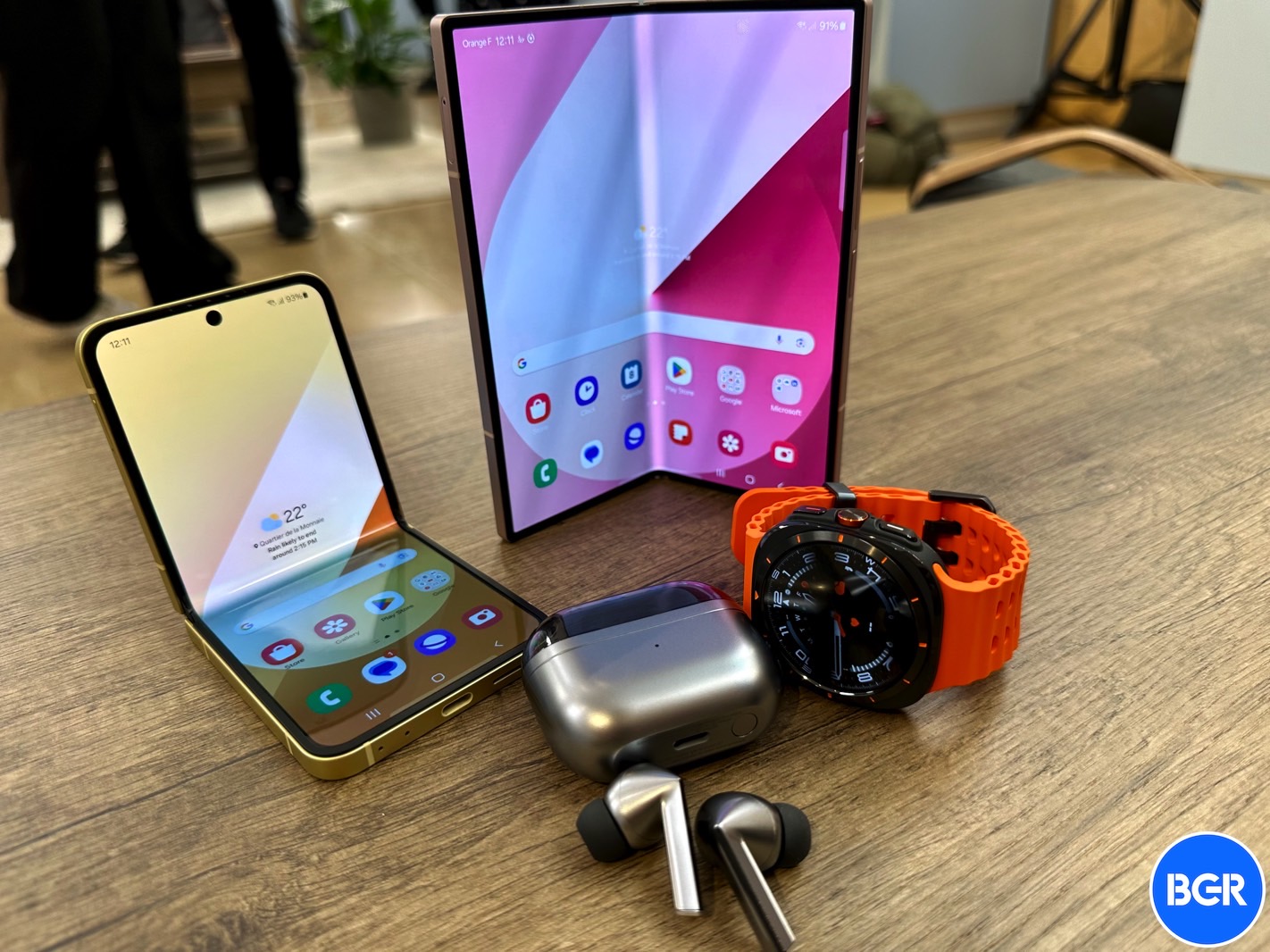 Galaxy Buds 3 Pro surrounded by Samsung's 2024 foldables and Galaxy Watch Ultra.