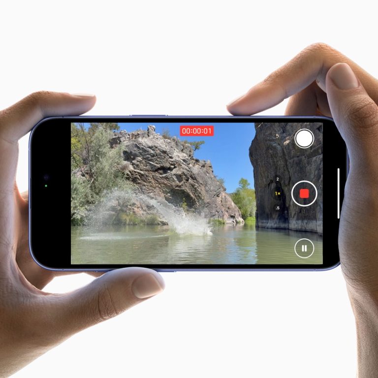 Using two hands to capture a photo with the Camera Control on the iPhone 16.