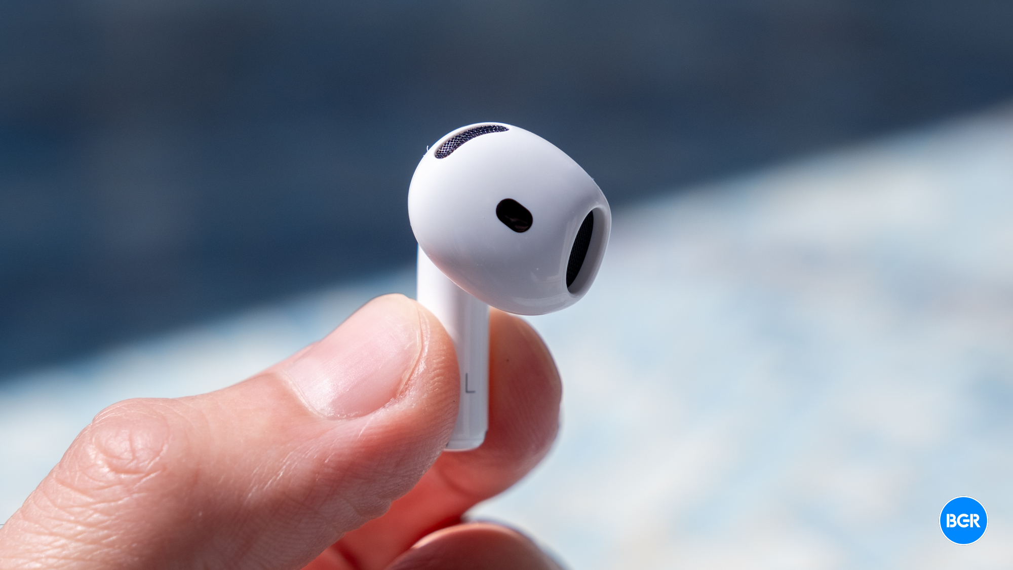 AirPods 4 earphone held