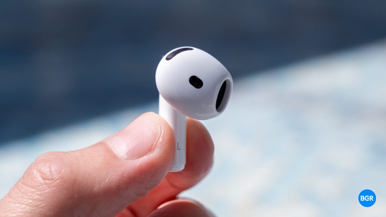 AirPods 4 earbuds are held