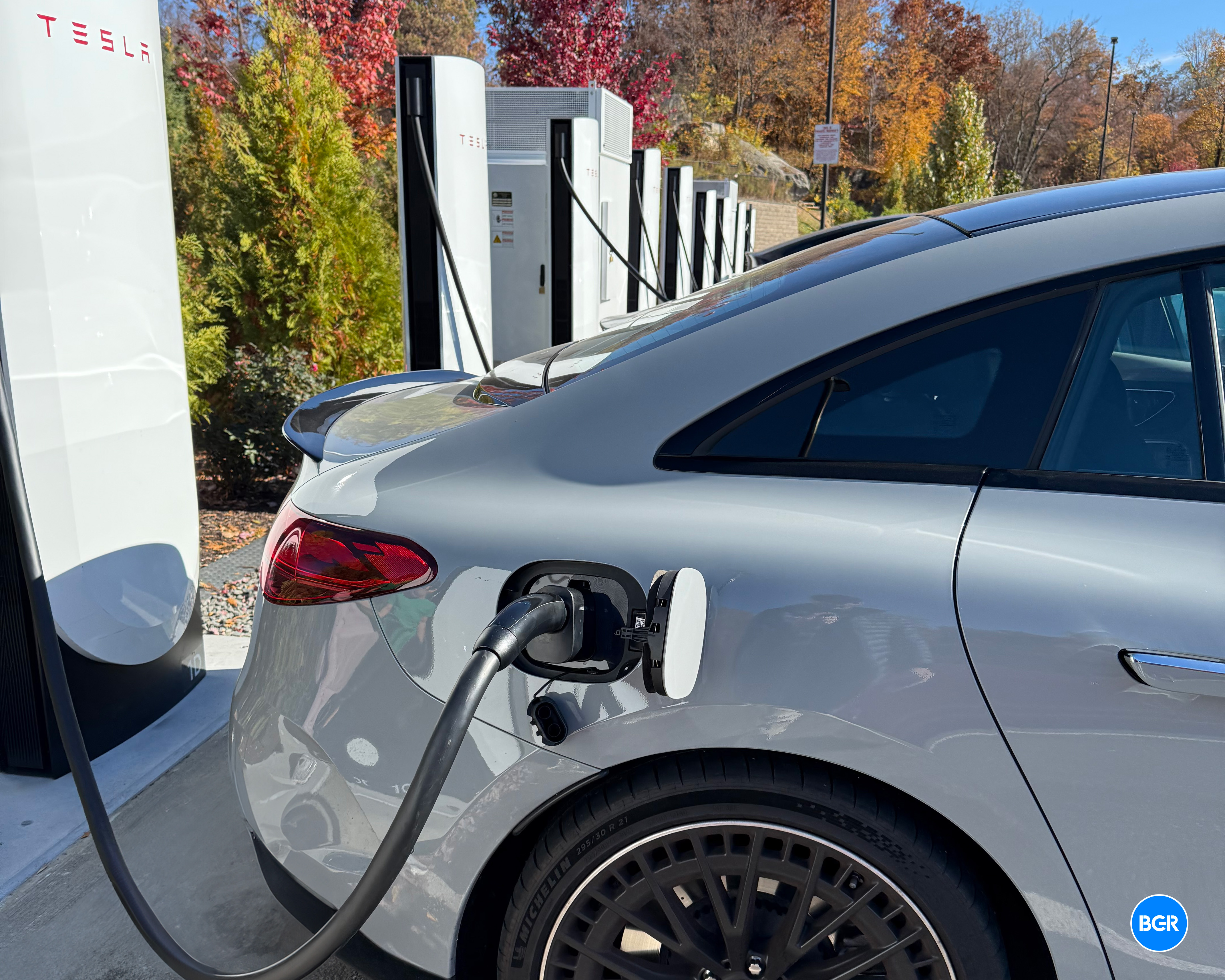 Mercedes EQE AMG charging at a Tesla Supercharger.