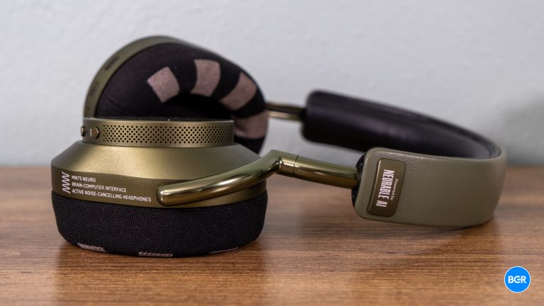 Green Master & Dynamic MW75 Neuro headphones lying flat on a table