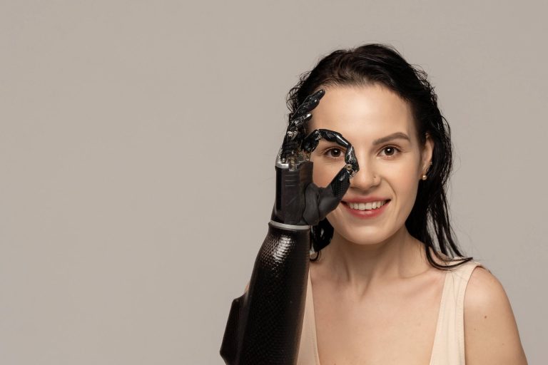 woman looking through fingers of prosthetic hand